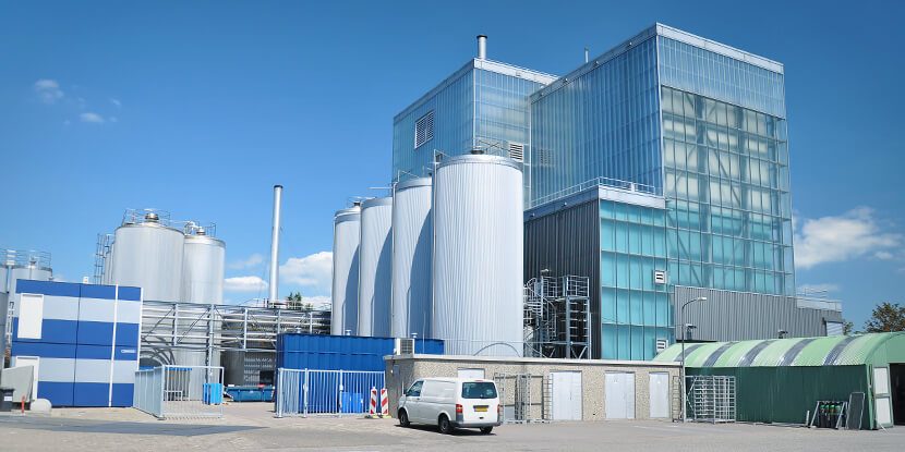 Industrial plant building with silos under a blue sky
